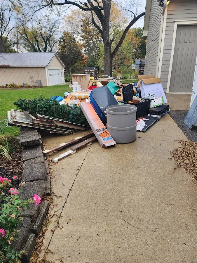 Dumpster being loaded with debris for Commercial Dumpster Rental in Lynn